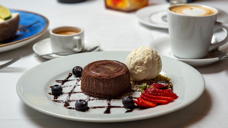 Chocolate cake dessert with berries and vanilla ice cream