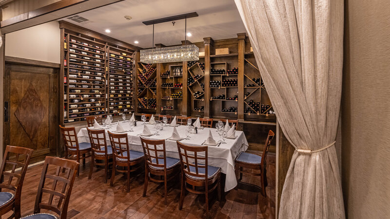 Wine room with view of table and curtain partition