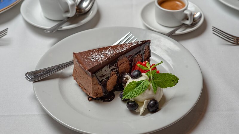 Chocolate cake with vanilla ice cream and berries