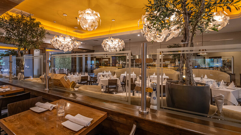 Main Dining Room with table set for two with view of other tables - Barka - Gallery Photo 3 Main Dining Room with table set for two with view of other tables